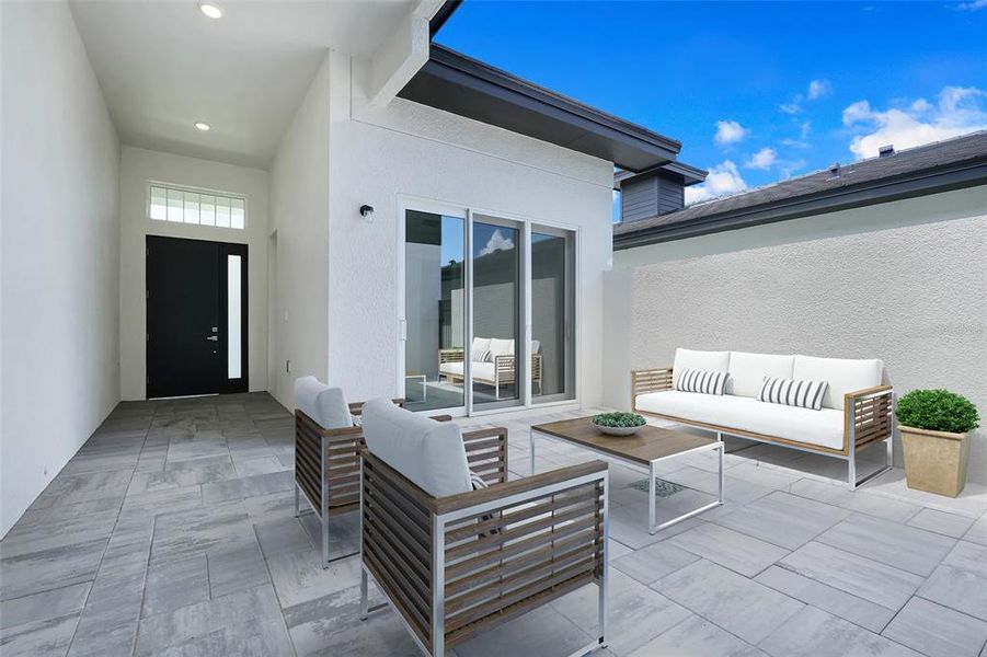 Exterior details and patio area of a home in Hampton Green at Providence, Davenport (Image 3).