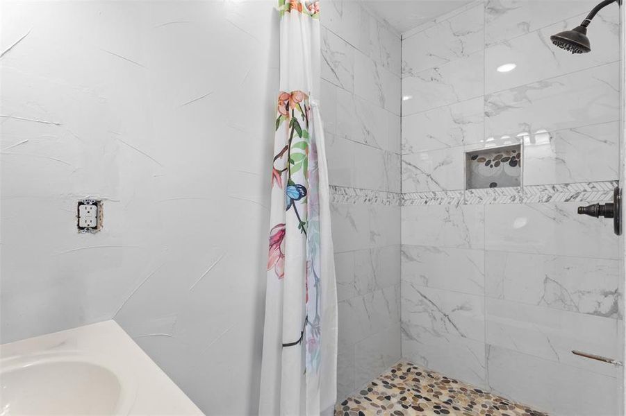 Bathroom with a tile shower and vanity Bathroom with a tile shower and vanity