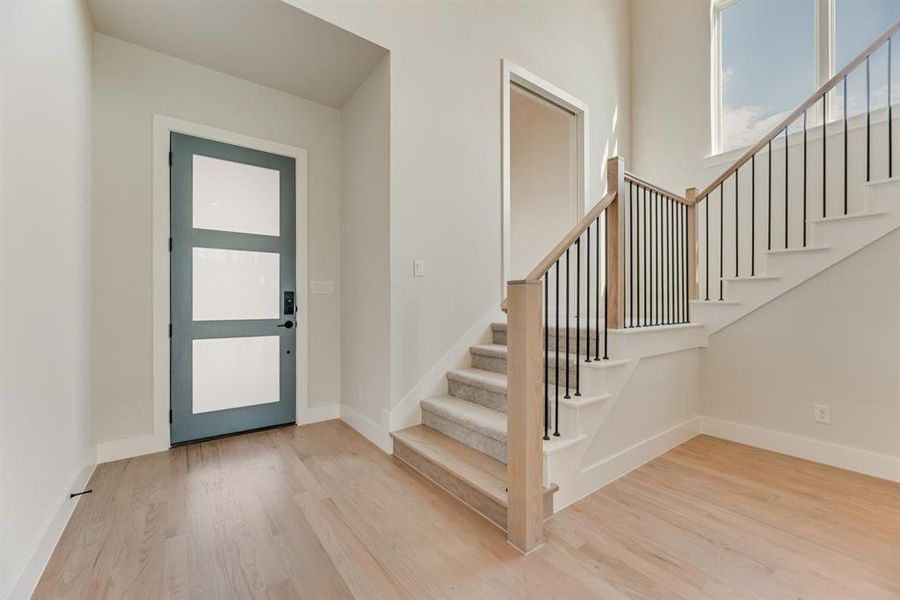 Foyer with stairs and light wood-style floors Foyer with stairs and light wood-style floors