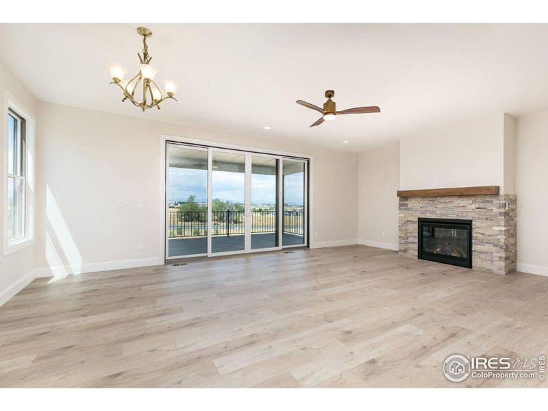 The living room fireplace is seen from the dining room and kitchen as well