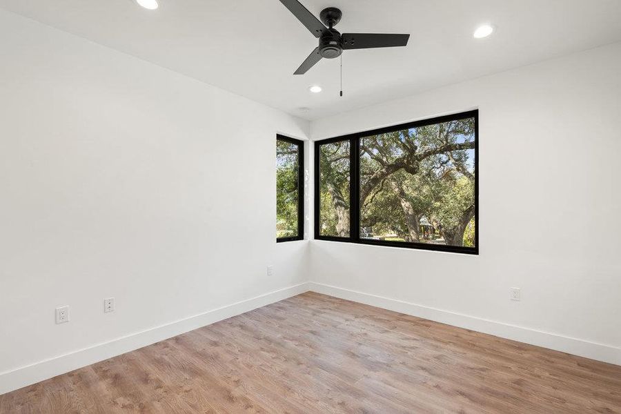 Empty room with light wood-type flooring, recessed lighting, and ceiling fan