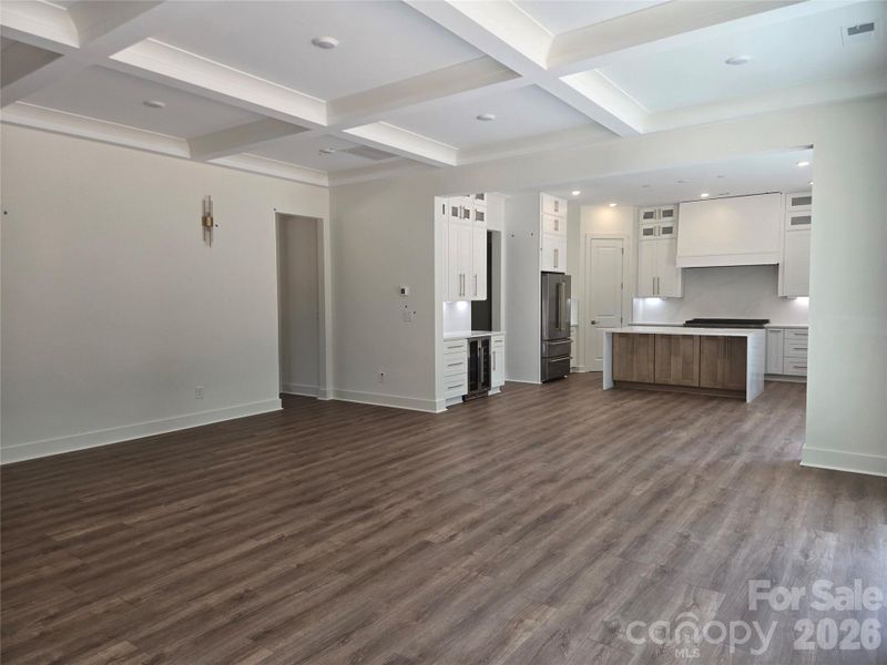 The great room has a coffered ceiling and wall sconces. The great room has a coffered ceiling and wall sconces.