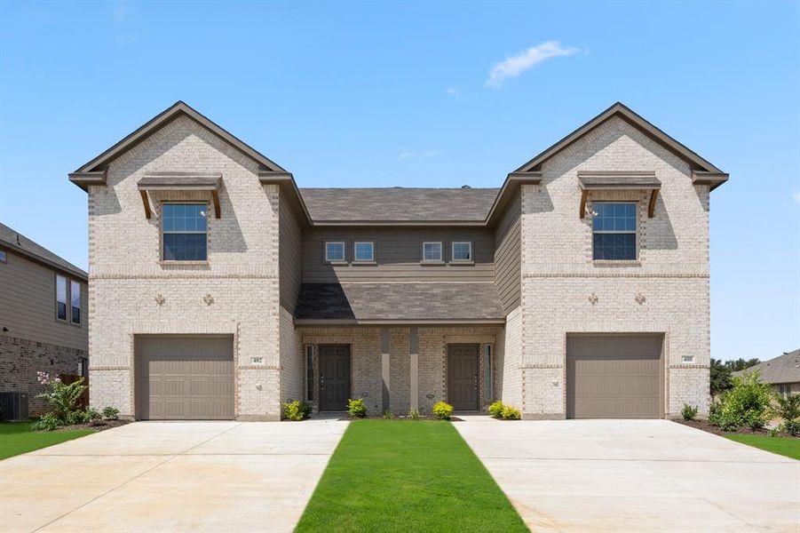 View of front of home with a garage and a front lawn