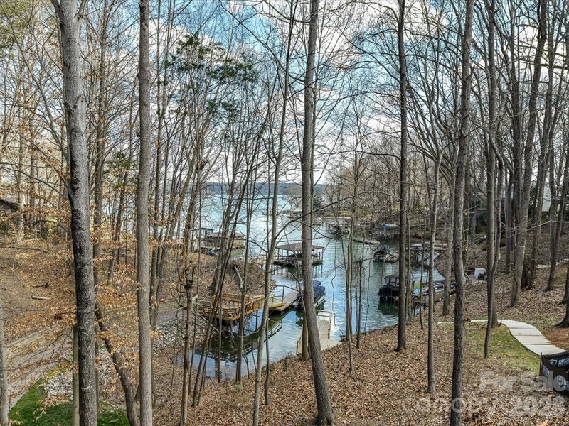 Aerial view highlighting the home’s prime wooded setting and still have the waterfront views of Lake Norman.