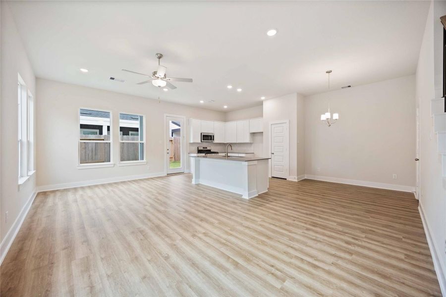 The open concept kitchen and family area create an inviting space for entertaining loved ones or finding solace after a busy day.