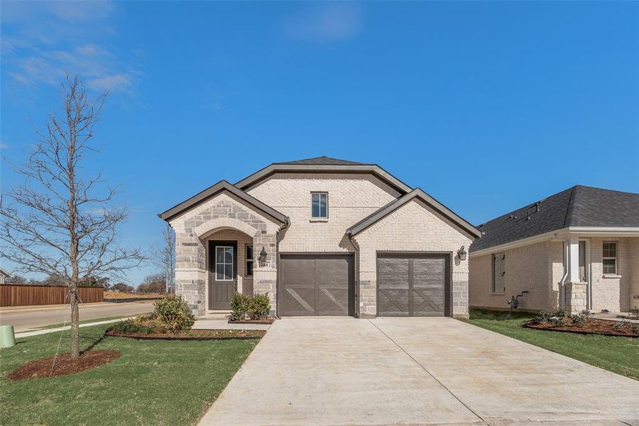 Front exterior of a new home in Spiritas Ranch, Little Elm, TX, highlighting curb appeal (Image 20).
