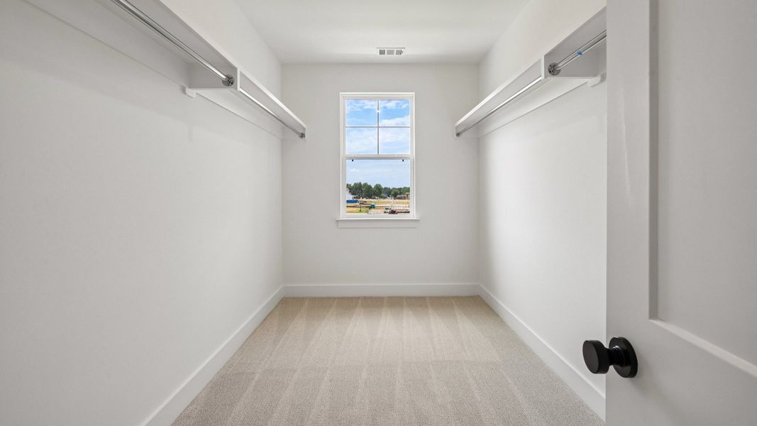 Primary closet with built-in shelf Primary closet with built-in shelf