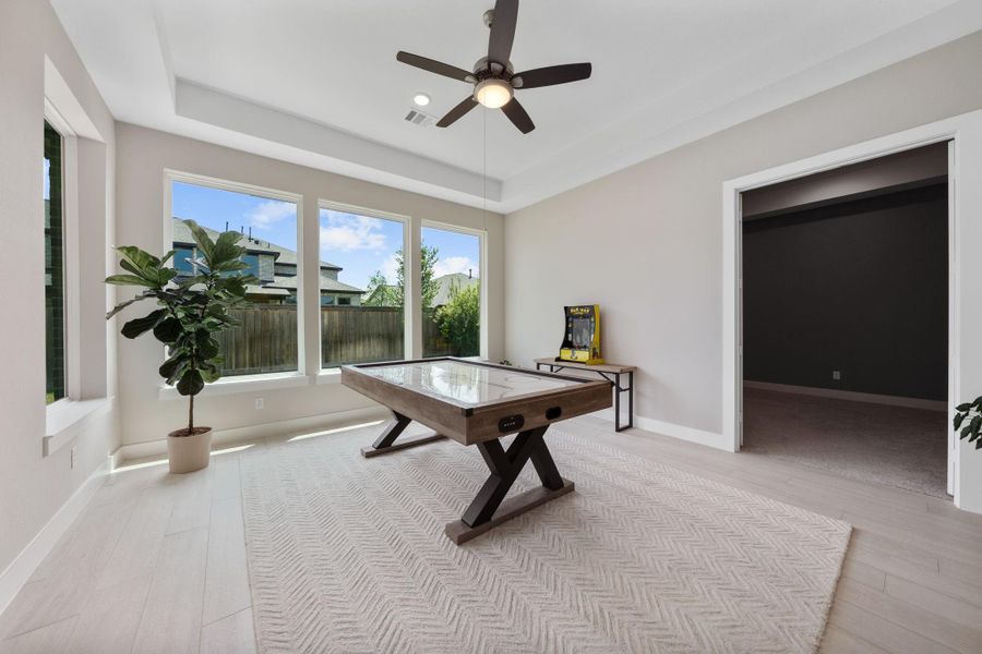 This fun and functional game room is the perfect spot for relaxation and entertainment, offering plenty of natural light through large windows that overlook the backyard. This fun and functional game room is the perfect spot for relaxation and entertainment, offering plenty of natural light through large windows that overlook the backyard.