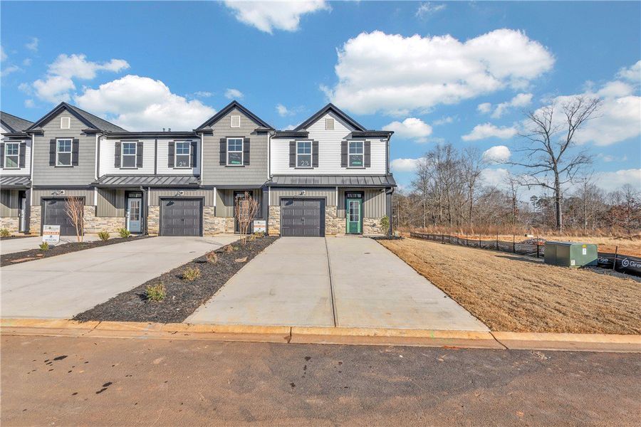 Front exterior of a new home in Meece Townhomes, Easley, SC, highlighting curb appeal (Image 15). Front exterior of a new home in Meece Townhomes, Easley, SC, highlighting curb appeal (Image 15).