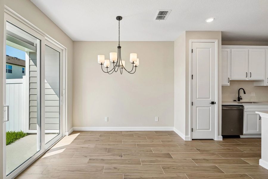 Dining space is located right off the kitchen and looks out on to the covered back lanai