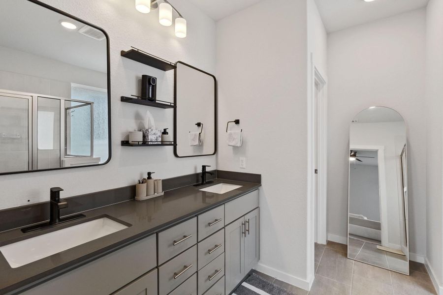 Bathroom featuring double vanity and mirrors