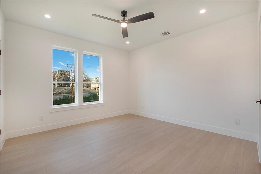 Unfurnished room featuring ceiling fan and light wood-type flooring