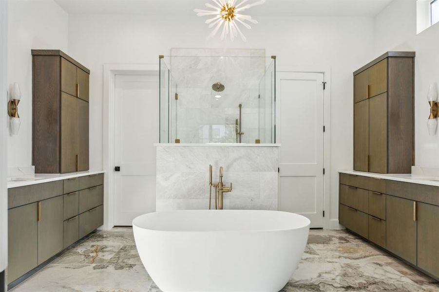 Primary bathroom with dual vanities, free standing tub and spacious shower. Primary bathroom with dual vanities, free standing tub and spacious shower.