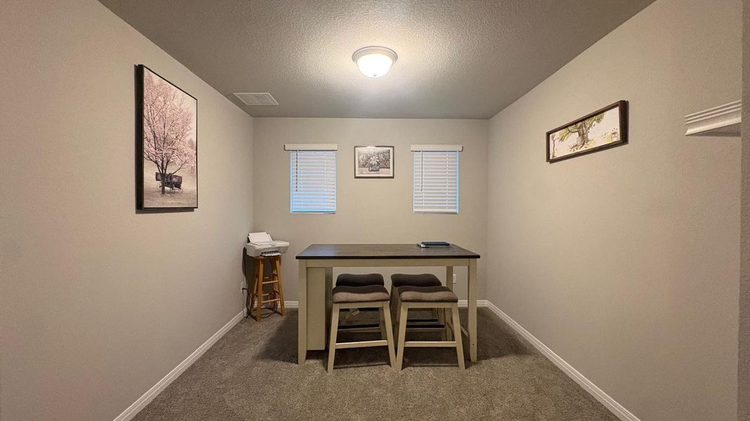 A well-proportioned interior room featuring ample wall space and natural light from two windows.