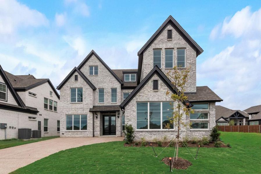 Front exterior of a new home in Cedar Ridge Estates, Grand Prairie, TX, highlighting curb appeal (Image 1). Front exterior of a new home in Cedar Ridge Estates, Grand Prairie, TX, highlighting curb appeal (Image 1).