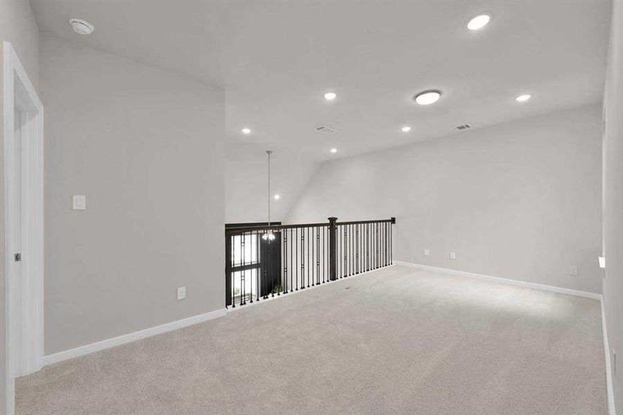 Open railing enhances the airy design overlooking the main living area. (Original builder photo w/out staging)