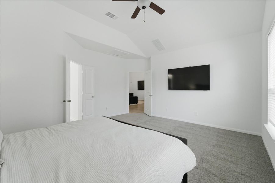 A spacious bedroom features vaulted ceilings and plush carpeting for comfortable living. A spacious bedroom features vaulted ceilings and plush carpeting for comfortable living.