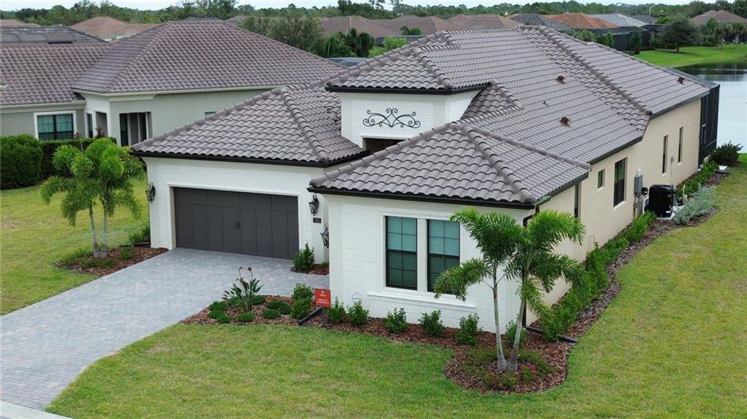 Front exterior of a new home in , Nokomis, FL, highlighting curb appeal (Image 1). Front exterior of a new home in , Nokomis, FL, highlighting curb appeal (Image 1).