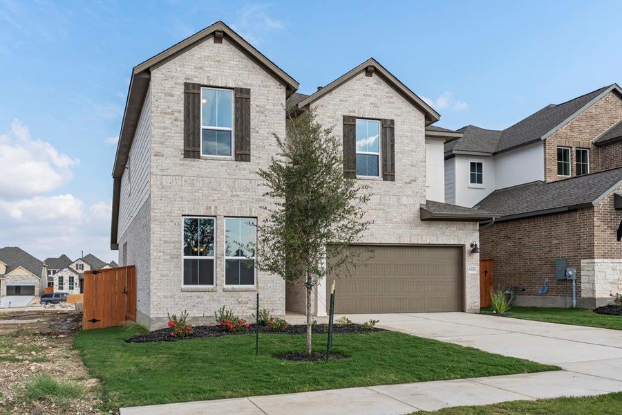 Front exterior of a new home in Lariat, Liberty Hill, TX, highlighting curb appeal (Image 1). Front exterior of a new home in Lariat, Liberty Hill, TX, highlighting curb appeal (Image 1).