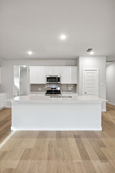 Kitchen in the Heisman home plan by Trophy Signature Homes – REPRESENTATIVE PHOTO