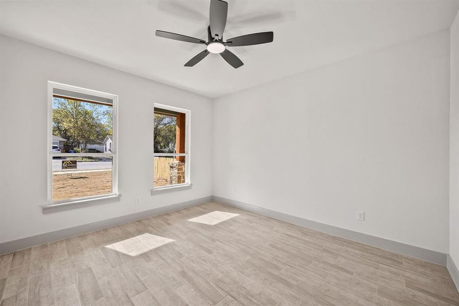 Spare room featuring light wood-style floors and a ceiling fan