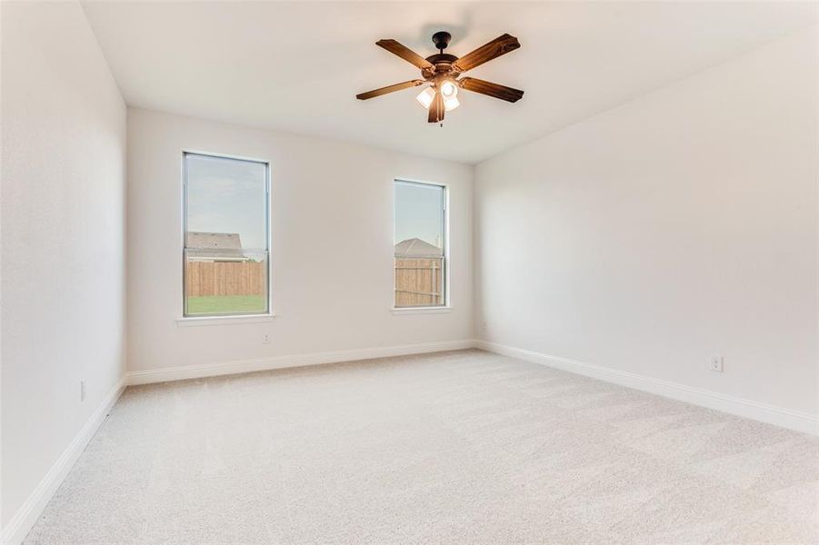 Unfurnished room with light carpet and ceiling fan