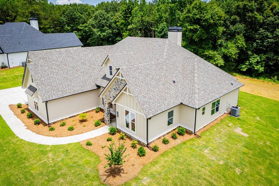 Front exterior of a new home in WOODMONT RESERVE, Roopville, GA, highlighting curb appeal (Image 28).