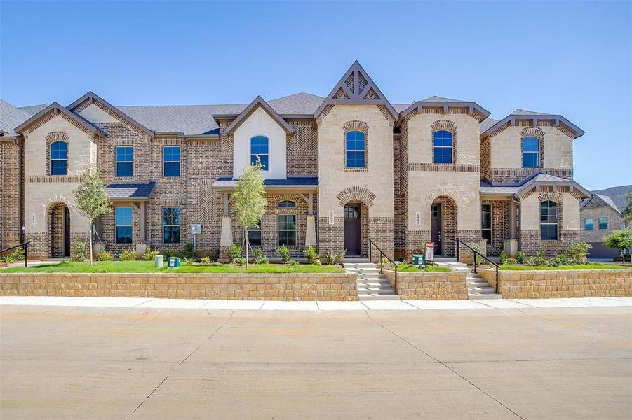 French country home with brick siding and stone siding French country home with brick siding and stone siding