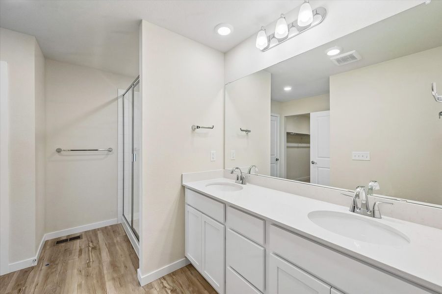 A bathroom with a large mirror.