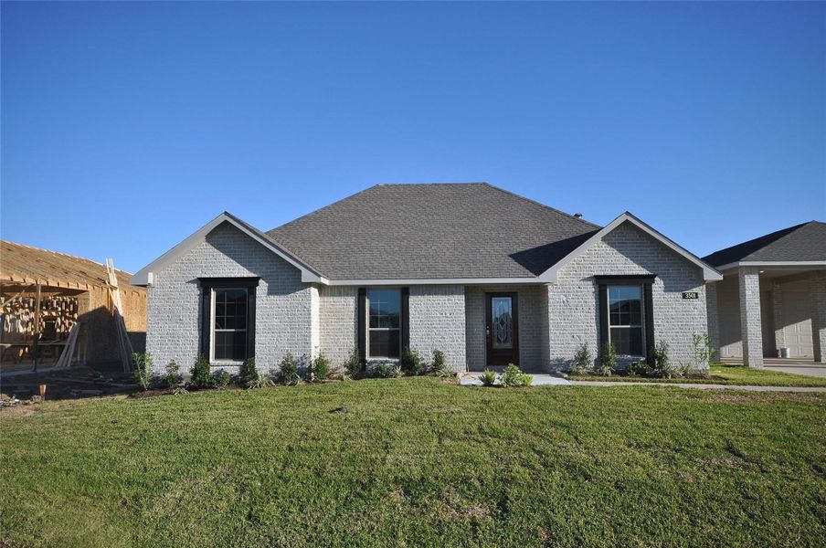 Front exterior of a new home in Pedregal, League City, TX, highlighting curb appeal (Image 1).
