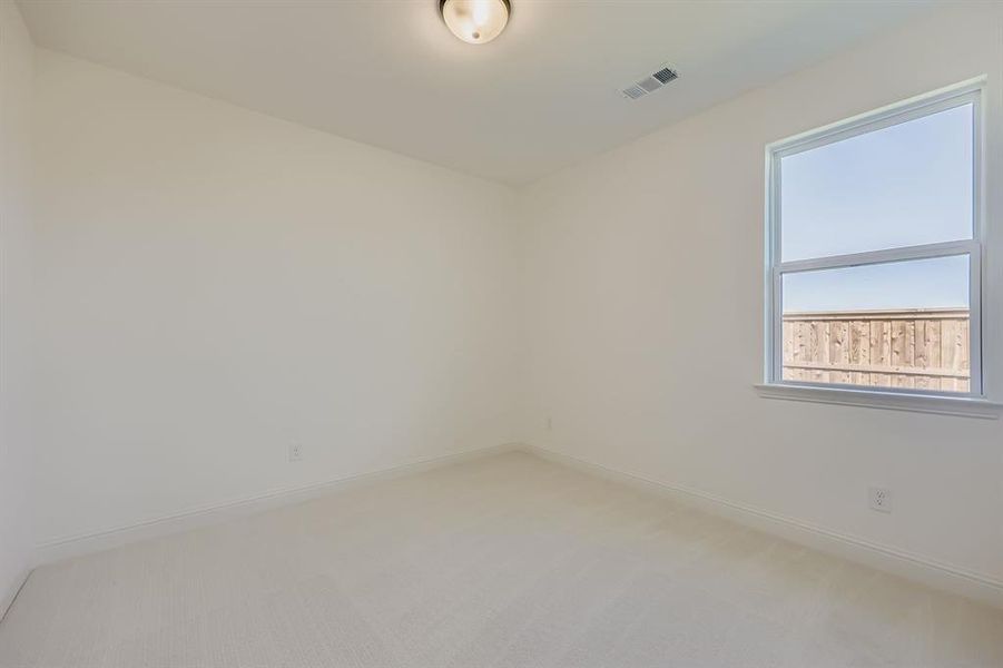 Empty room with carpet and baseboards