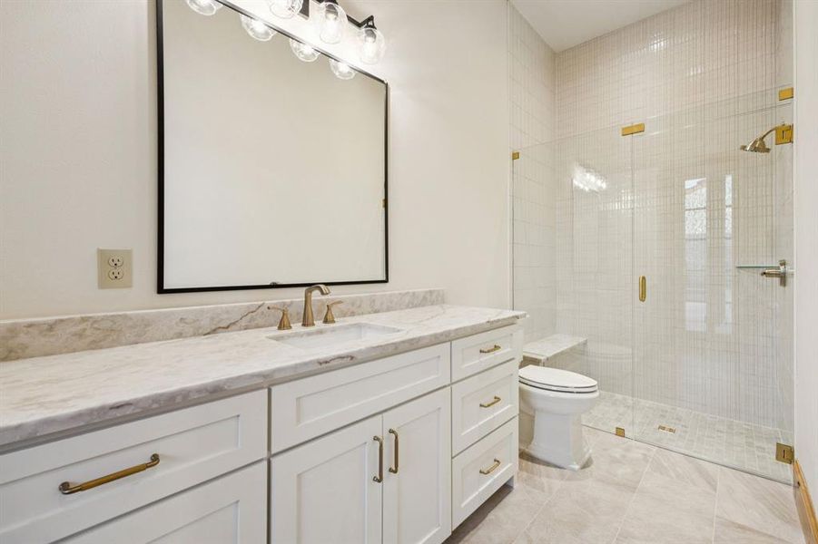 Bathroom featuring vanity, a stall shower, and light tile patterned floors
