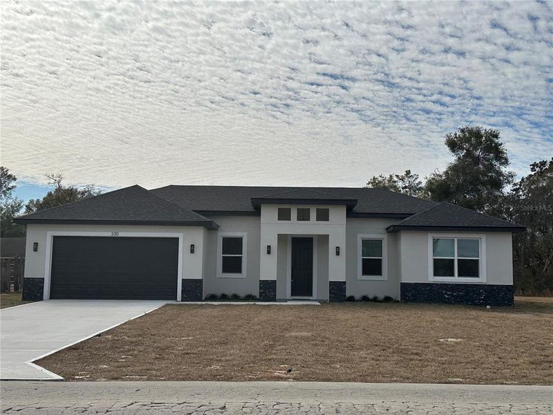 Front exterior of a new home in , Dunnellon, FL, highlighting curb appeal (Image 18).