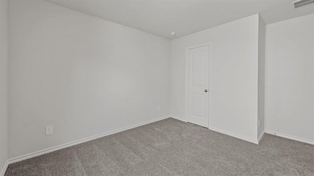 Neutral-toned wall paint throughout, complemented by light gray carpeting
