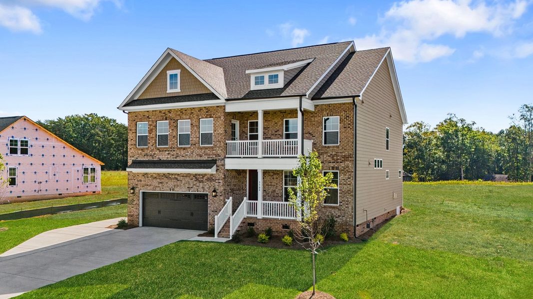 Front exterior of a new home in Lilah Grove, Summerfield, NC, highlighting curb appeal (Image 2). Front exterior of a new home in Lilah Grove, Summerfield, NC, highlighting curb appeal (Image 2).