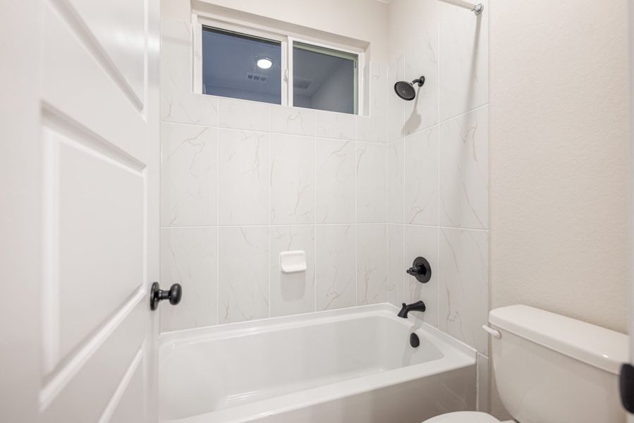Representative furnished interior of a home built from the Mackenzie by Chesmar Homes in Sienna Lakes, San Antonio (Image 9).