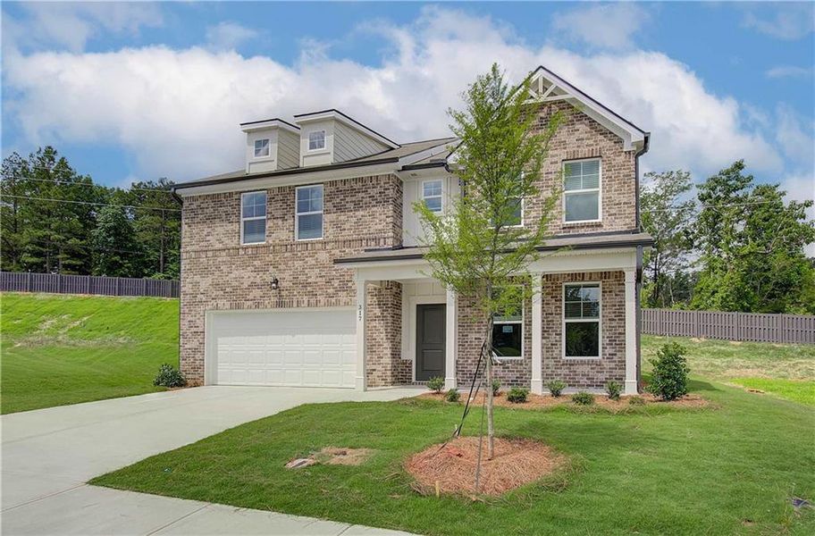 Front exterior of a new home in Kingsmere Estates, Loganville, GA, highlighting curb appeal (Image 25).