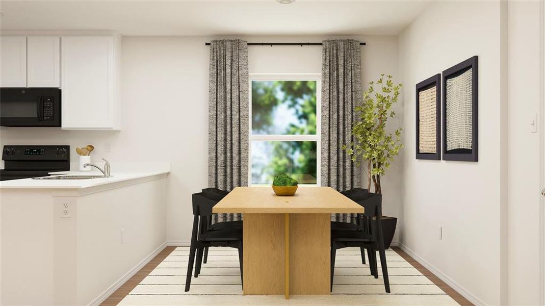 Dining area featuring sink and light wood-type flooring