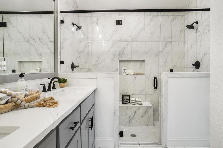 Bathroom featuring an enclosed shower and vanity