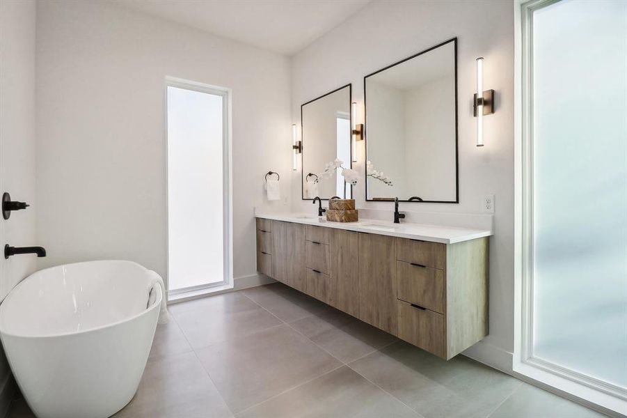 Bathroom with vanity, a tub, and tile patterned floors