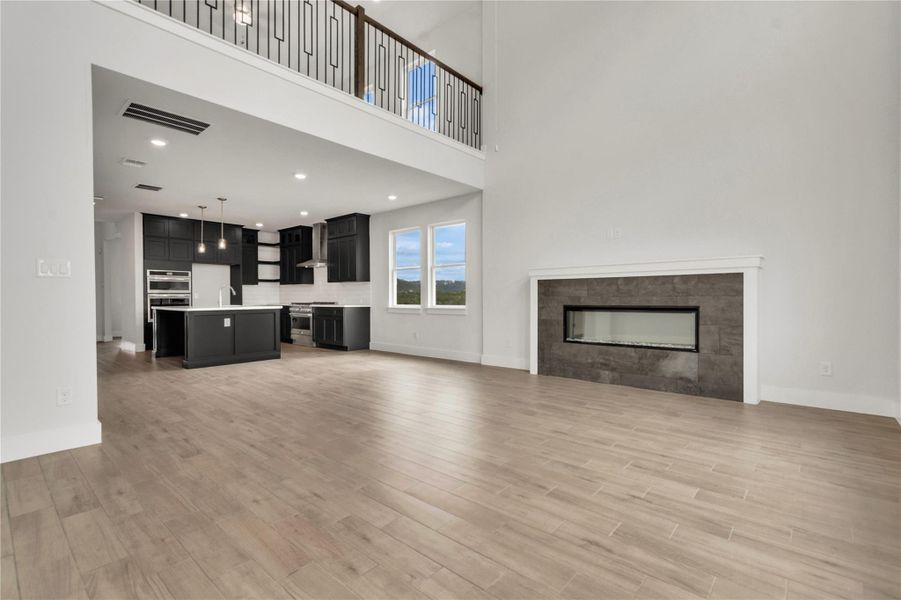 An open concept living area boasts a modern fireplace, ideal for entertaining guests.