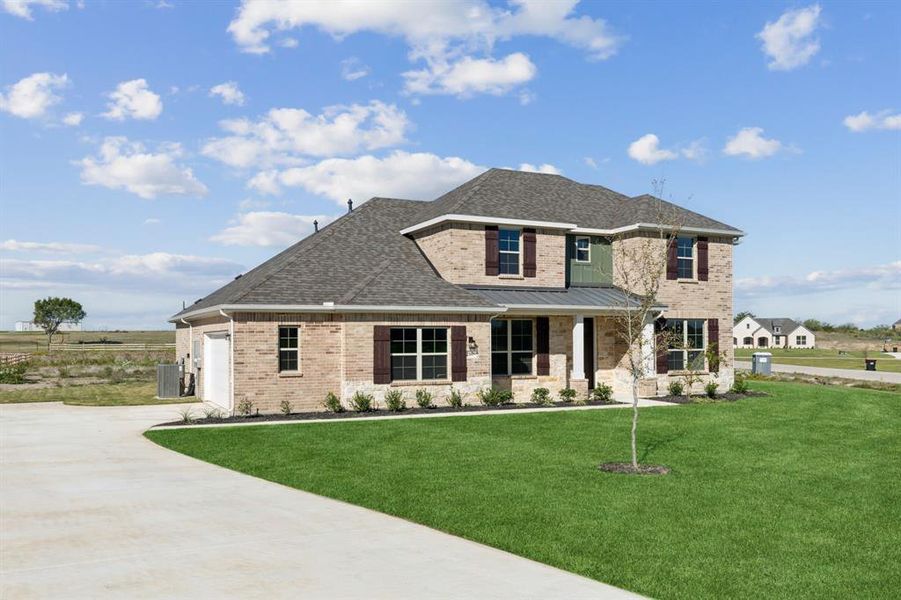 View of front facade with a garage and a front lawn