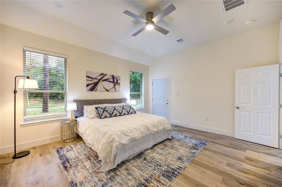 Spacious primary bedroom with ample natural light and modern finishes.