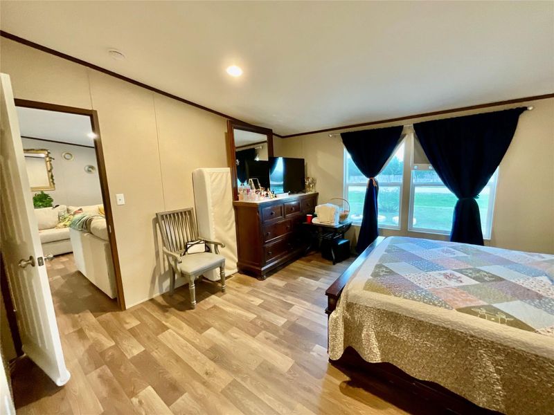 Room4  featuring wood-finish flooring, neutral wall panels, and two windows