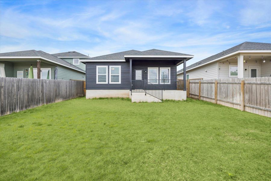 Back of property featuring a fenced backyard