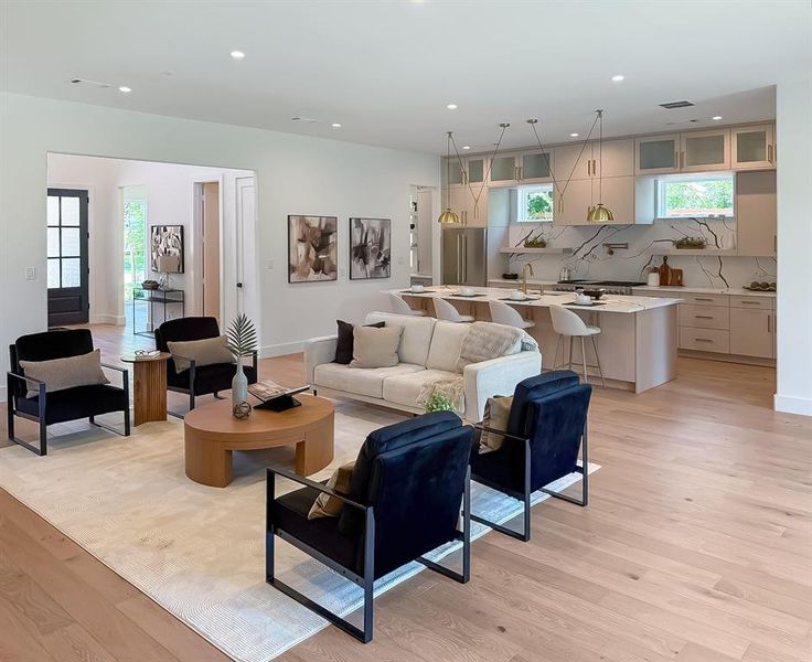 Living room featuring light wood finished floors and recessed lighting Living room featuring light wood finished floors and recessed lighting