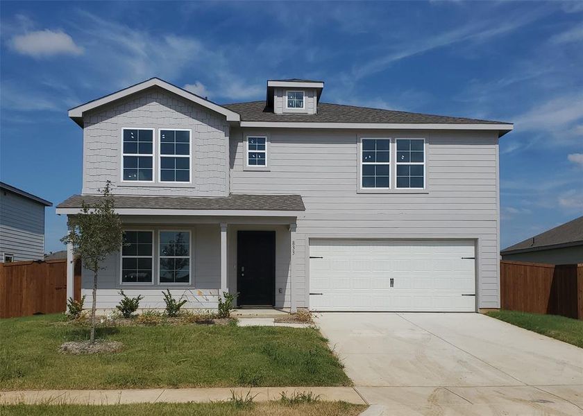 View of front of property featuring a garage and a front lawn