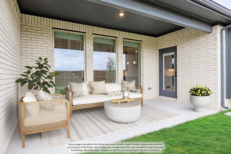 Covered back patio with light brick walls, outdoor sofa, chair, and round coffee table on concrete slab.