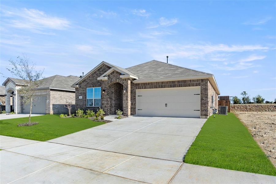 Ranch-style home with a front lawn, central AC unit, and a garage