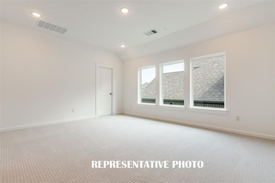 A wall of windows floods the spacious game room with natural light.  REPRESENTATIVE PHOTO